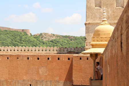 Indian man looking at the detail of Amer (or Amber) Fort in Jaipur. One of six Hill Forts of Rajasthan. Taken in India, August 2018.のeditorial素材