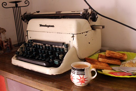 Translation: the vintage typewriter Remington or type machine and a cup of chai tea, served in a unique cup. So stylish and great to start a perfect morning!のeditorial素材