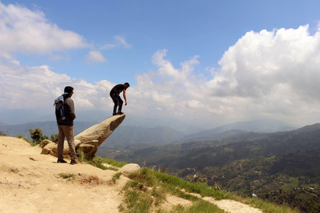 Good Nepali friends are helping to take photos on a stone. Taken in Dhulikhel, Nepal, August 2018.のeditorial素材