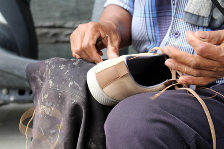 Process of manual shoe reparation, sole and welt fixing and stitching. Taken in Indonesia.の写真素材