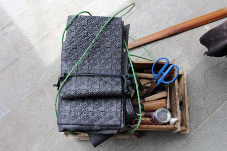The equipment used for manual shoe sole sticthing stored in a wooden cart.