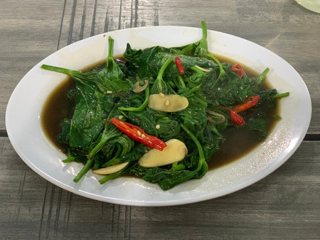 Closeup of cah kangkung, kangkong, or water spinach stirred.
