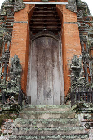 Entrance of Taman Ayun made of bricks and wooden door. Taken January 2022.のeditorial素材