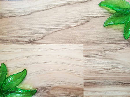 Decorative green glass leaves composition on wooden pattern.の写真素材