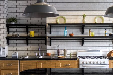 White brick kitchen detail with cooking accessoriesの写真素材