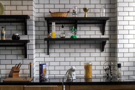 White brick kitchen detail with cooking accessoriesの写真素材