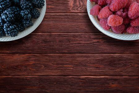 Blackberries and raspberries on rustic wooden tableの写真素材