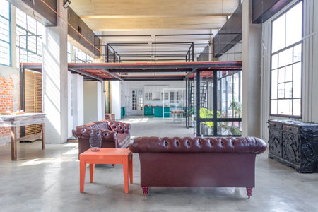 Wide loft with high ceiling, and blue and white kitchen, and white floor
