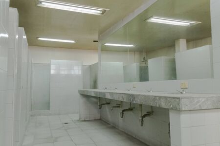white washbasins in abandoned gym with mirrorの写真素材
