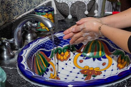 Hygiene concept Wash your hands with soap and water. In handmade sinkの写真素材