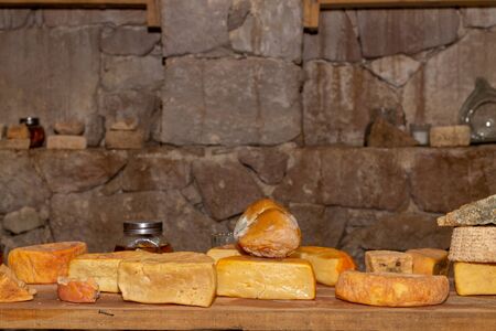 Table with cheese and wine glasses win side the tasting room of old cellarの写真素材