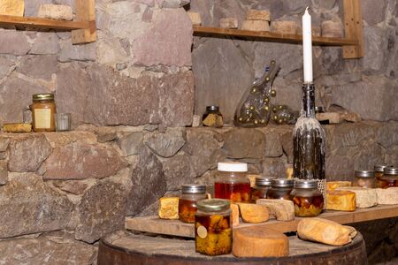 Table with cheese and wine glasses win side the tasting room of old cellarの写真素材