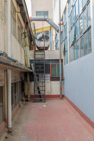 exterior corridor in abandoned building with brown floor