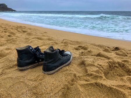 sneakers on the sea coast, waiting for its ownerの写真素材