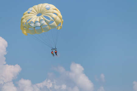 Yellow wing with happy face from skydiving pulled by a boat. Summer maritime recreationの写真素材