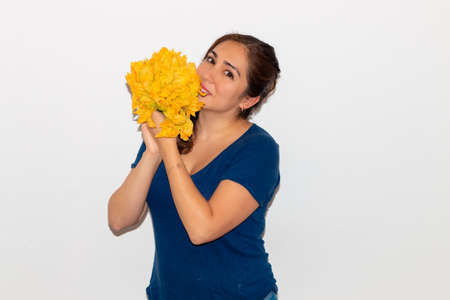 Real young man with a bunch of pumpkin flower. Isolated on a white background. Copy spaceの写真素材