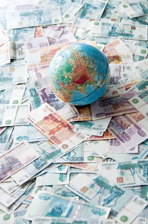 Globe on Russian money. Globe lies on the Russian ruble different denominationsの写真素材