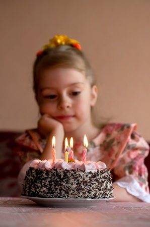 Birthday. The little girl make a wish before you blow out the candlesの写真素材