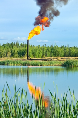 Oil torch with reflection in waterの写真素材