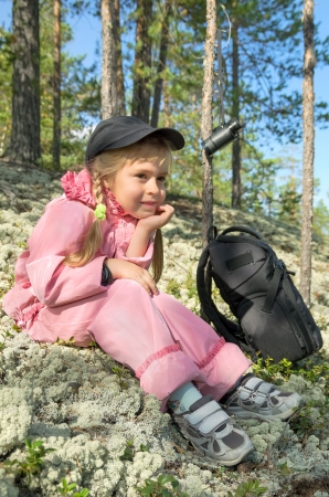 The little girl on a halt in the forestの写真素材