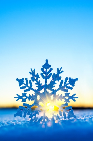 Decorative snowflake against the setting sunの写真素材