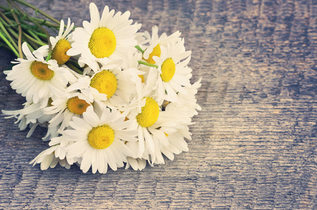 Bouquet of daisies on the board in vintage styleの写真素材
