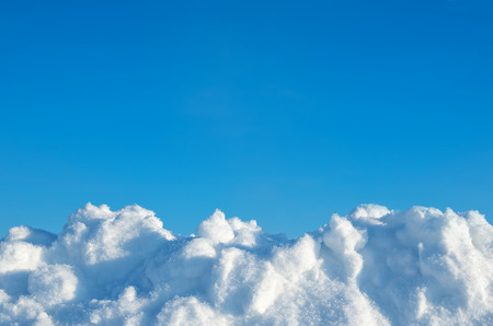 Fresh snow on a background of blue skyの写真素材