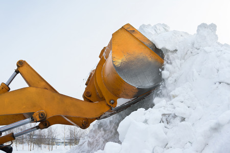 The bulldozer clears away snow driftsの写真素材