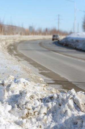 A pile of dirty snow on the side of the roadの写真素材