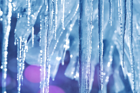 Background of bright transparent icicles in the sunlightの写真素材