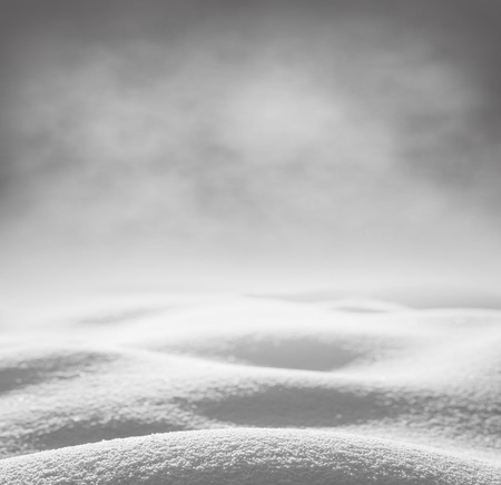 Winter background. Winter bright landscape with snowdrifts and falling snow.の写真素材