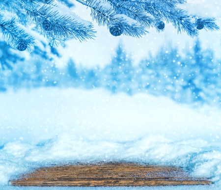 Winter bright background with snow-covered old table.の写真素材