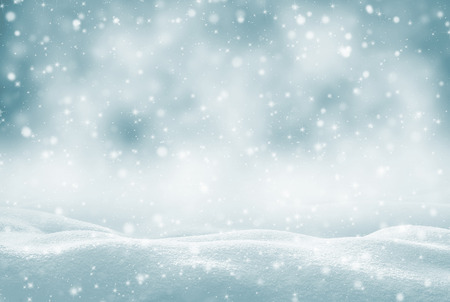 Winter background. Winter bright landscape with snowdrifts and falling snow.の写真素材