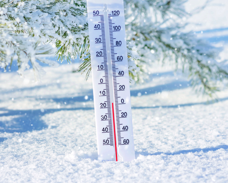 Wintertime. Winter background with  thermometer in the snow on frosty day.の写真素材