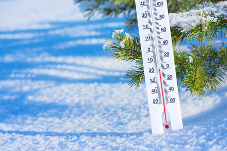 Wintertime. Winter background with  thermometer in the snow on frosty day.の写真素材