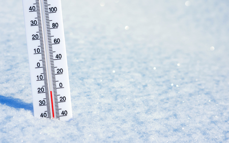Winter background with thermometer in clean shiny snow.の写真素材