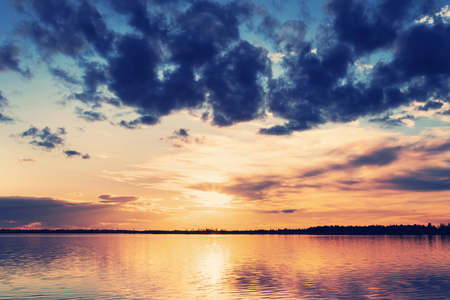 Bright beautiful landscape. Landscape with colorful dramatic sunset over the lakeの写真素材