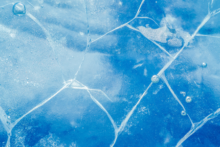 Abstract ice background. Blue background with cracks on the ice surfaceの写真素材