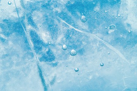 Abstract ice background. Blue background with cracks on the ice surfaceの写真素材