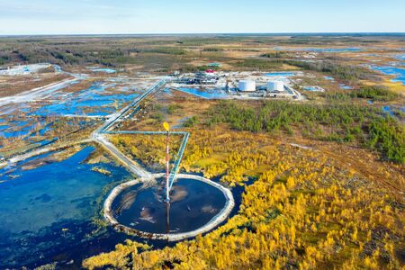 Autumn industrial landscape. Western Siberia. Oil torch. Associated gas burning during oil production.の写真素材