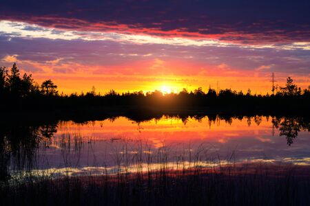 Beautiful evening landscape. Beautiful evening landscape. Colorful sunset. Bright sunset sky is reflected in the water of the lake.の写真素材