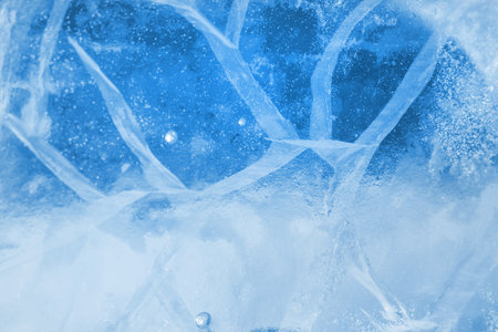 Abstract ice background. Blue background with cracks on the ice surfaceの写真素材