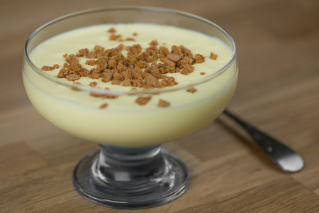 Close up of mascarpone cream with cookies on a wooden tableの写真素材