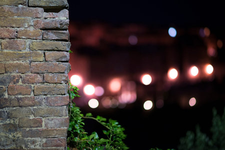 Brick red wall and bokeh from the street by night