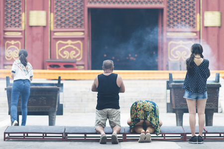Beijing, China - 08 01 2016: Chinese people praying in front of a temple in Beijing, Chinaのeditorial素材