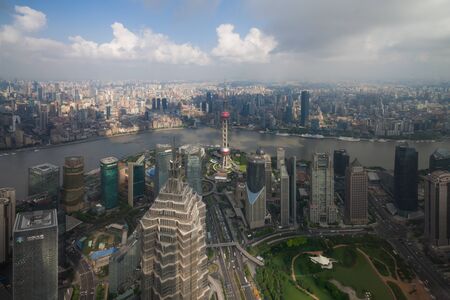 Aerial View of Shanghai Cityscape overlooking the Pudong Financial District with blue sky and clouds. Trade Area skyline and Huangpu River, Shanghai, Chinaのeditorial素材