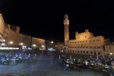 Tourists in Piazza del Campo by night, Siena, Italy. The historic center of Siena. UNESCO World Heritage Siteのeditorial素材