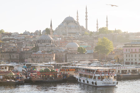 Istanbul, Turkey - 04 22 2016: Floating restaurants and the New Mosque Yeni Cami in Eminonu. View from Galata Bridge, Golden Horn, Istanbul, Turkeyのeditorial素材
