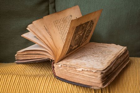 very small and old bible in spanish with many damaged pages found in a grandfather's libraryの写真素材
