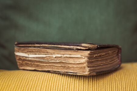 very small and old bible in spanish with many damaged pages found in a grandfather's libraryの写真素材